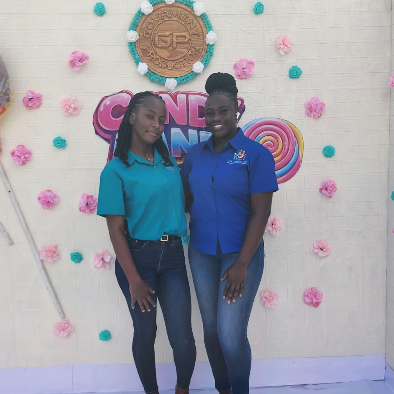 Two Bradey’s team members at the Candy Land party backdrop